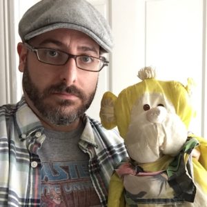 Josh Funk holding a stuffed monkey toy